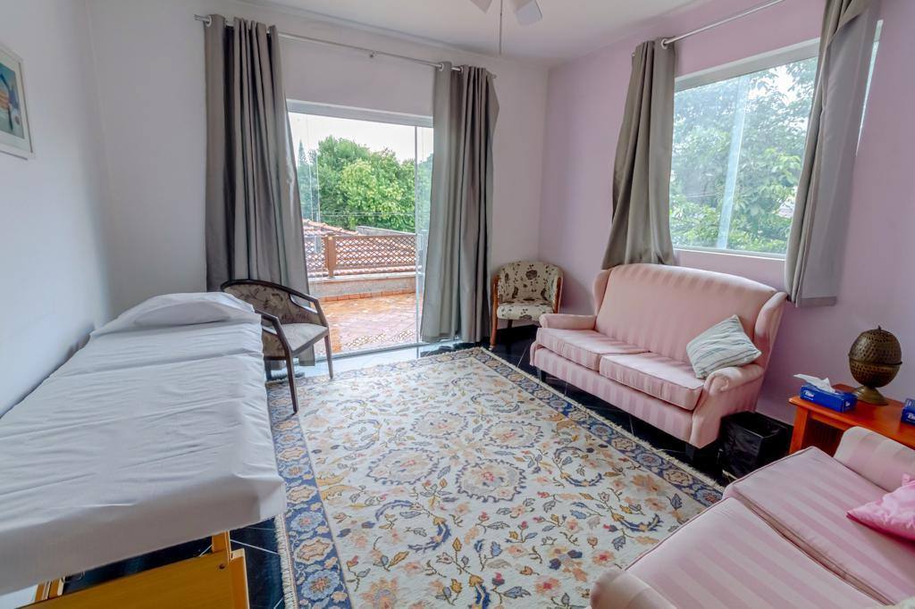 Sala iluminada com sofá e tapeçaria floral